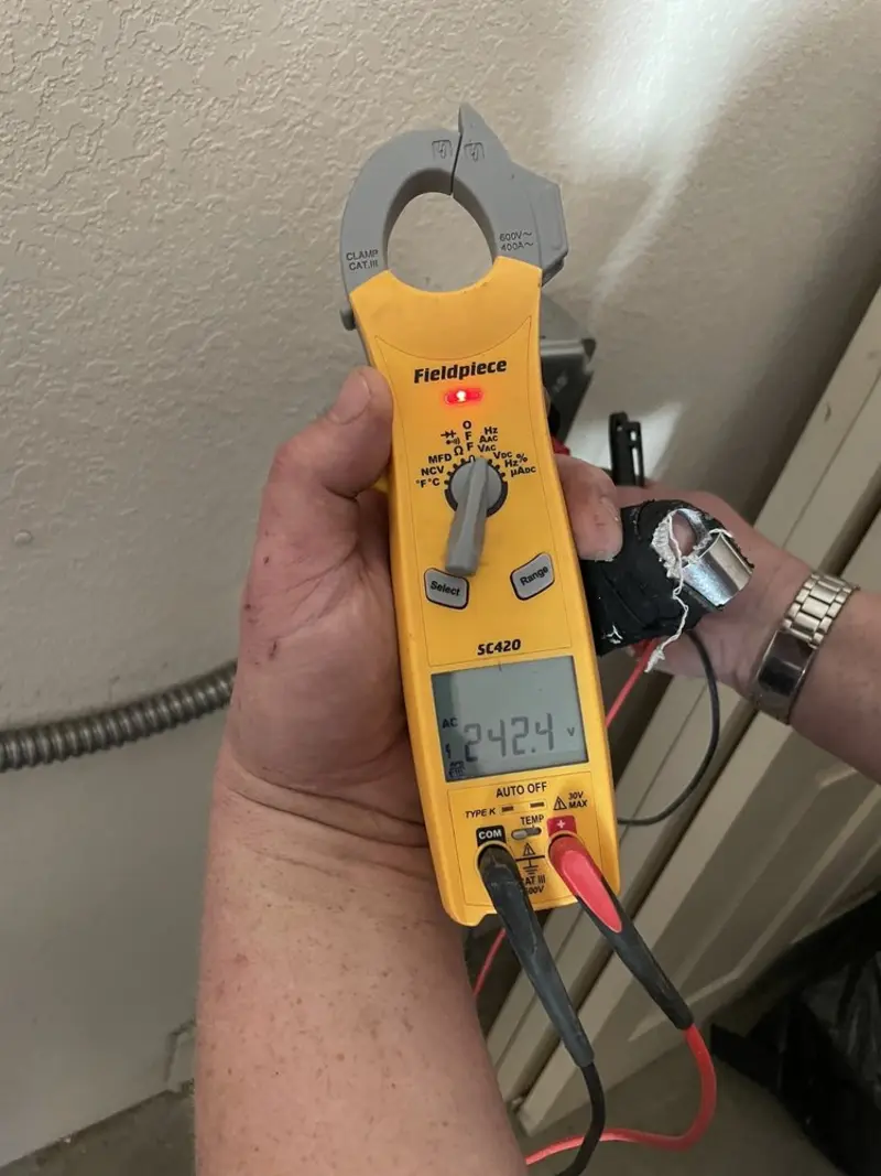 Voltage testing with clamp meter during Whole House Surge Protector in Manchester